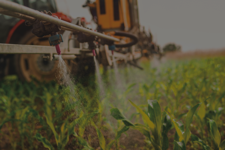 up close of tractor spraying field